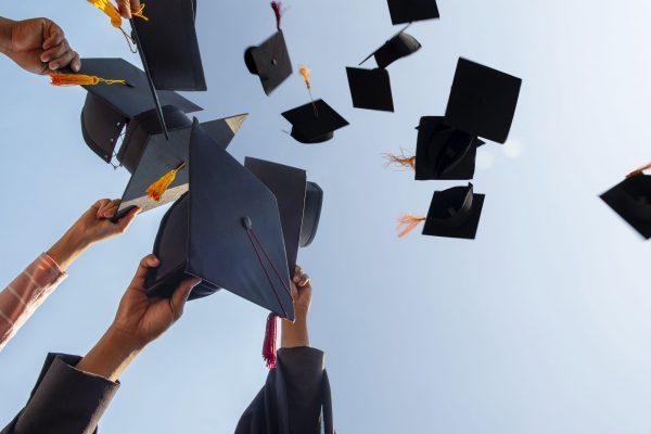 cropped-hands-of-people-throwing-mortarboards-royalty-free-image-1649367603